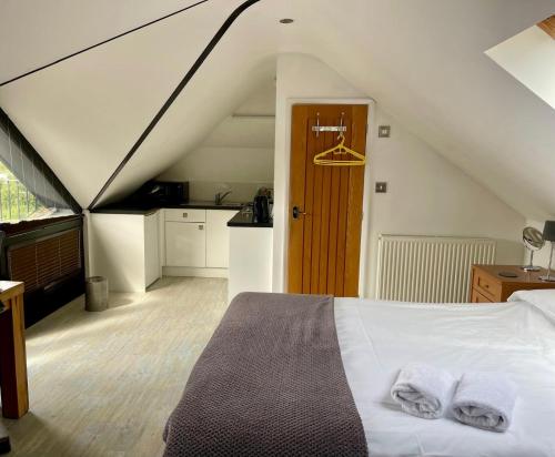 a bedroom with a bed with two towels on it at Hunters Hide Apt in Littlehampton