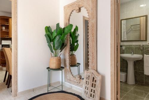 a bathroom with a mirror and a sink at Casa Susana in Santa Eularia des Riu