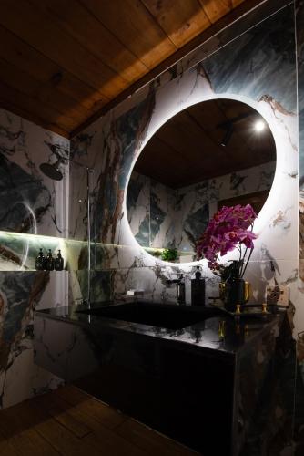 a bathroom with a sink and a mirror at Secret Garden Kalam in Kalām