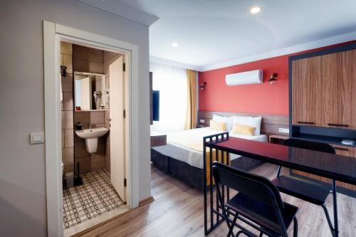a hotel room with a bed and a table and chairs at Terra Rossa in Antalya
