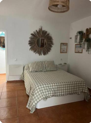 a bedroom with a bed and a mirror on the wall at Villa guiris in Barbate