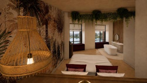 a bedroom with a large bed and a bath tub at Van der Valk Hotel Maastricht-Maas in Maastricht