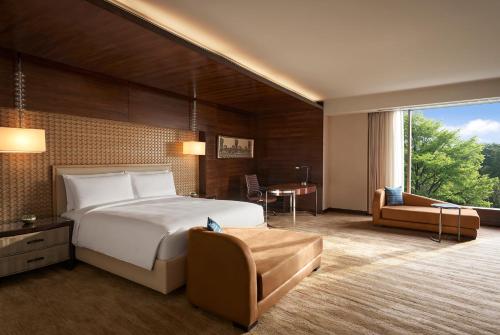 a hotel room with a large bed and a desk at JW Marriott Hotel Chandigarh in Chandīgarh