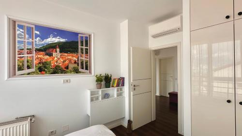 a room with a window with a view of a city at Central Premium Apartment in Braşov