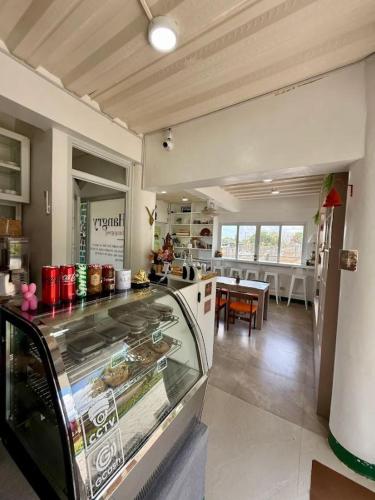 a kitchen with a counter and a dining room at The Stables by L' Rancho Danilo in Banaba