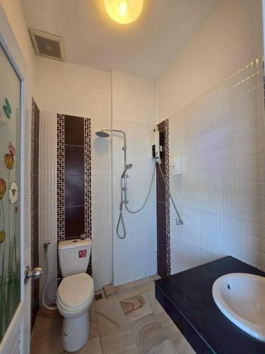 a bathroom with a shower and a toilet and a sink at เสม็ดทาวน์ Samed Town in Ko Samed