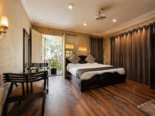 a bedroom with a bed and a table and a window at Lidder view resort in Muski