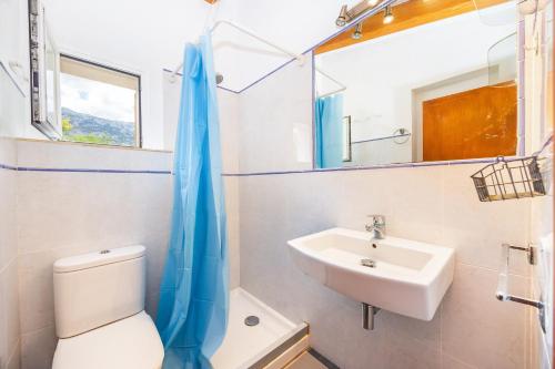 a bathroom with a toilet and a sink at Can Pep in Sóller