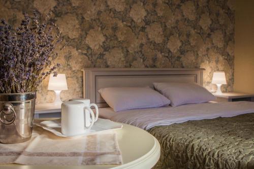 a bedroom with a bed and a table with a coffee mug at Mini Hotel Ryleev in Kharkiv