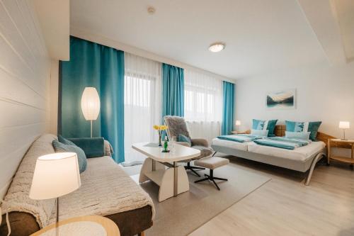 a living room with a couch and a table at Ferienappartement Donautal in Obernzell