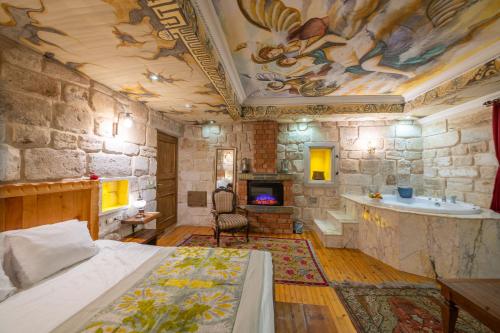 a bedroom with a bed and a stone wall at Corner İn Cappadocia in Ortahisar