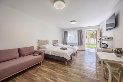 a living room with two beds and a couch at DANUBike in Dobrohošť
