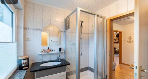 a bathroom with a sink and a shower at YALET Ferienhaus 2 appartementen vlakbij Willingen in Brilon-Wald