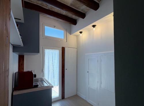 a kitchen with a sink and a window in a room at Donna Lucia Apulian Experience in Ruvo di Puglia