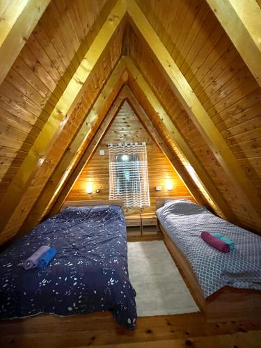 a room with two beds in a attic at Vikendica Anja in Žabljak