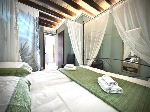 a bedroom with a bed with two towels on it at Donna Lucia Apulian Experience in Ruvo di Puglia