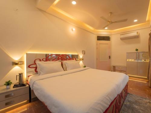 a bedroom with a large white bed in a room at The Collectors Loft in Jaipur