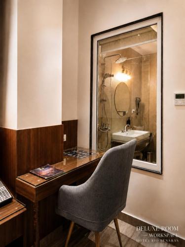 a desk with a chair and a sink in a bathroom at HOTEL RIO BENARAS in Varanasi
