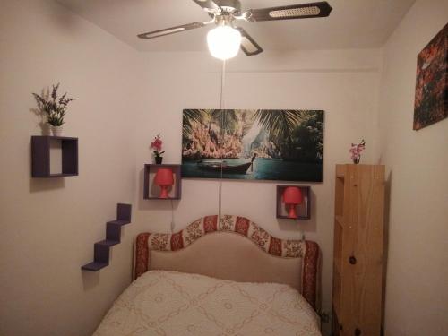 a bedroom with a bed and a ceiling fan at Town House in Pego in Pego