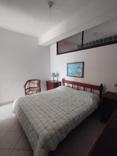 a bedroom with a bed and a table and a chair at Apartamento en puerta del sol 17 in La Loma