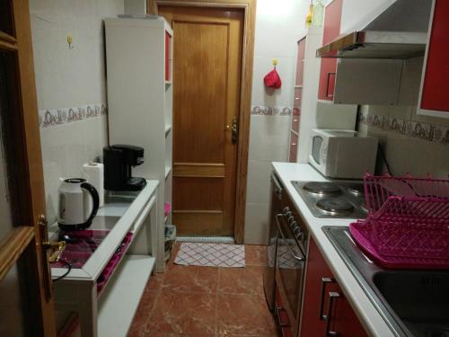 a small kitchen with a stove and a microwave at Town House in Pego in Pego