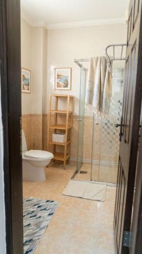 a bathroom with a toilet and a glass shower at Spacious Villa with Sea and Mountain View in Kemer