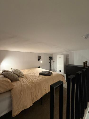 a bedroom with a large bed with pillows on it at Grant City Loft in Kaunas