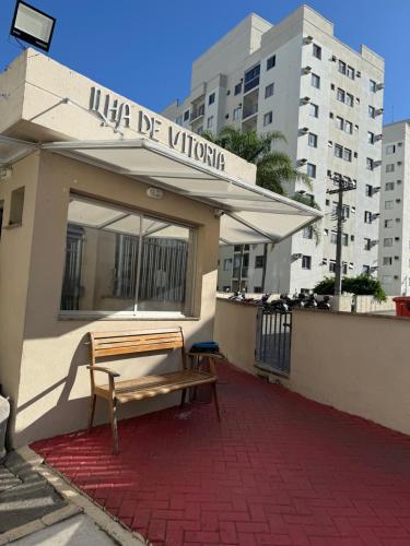 a bench sitting in front of a building at Apartamento Serra Espírito Santo in Serra
