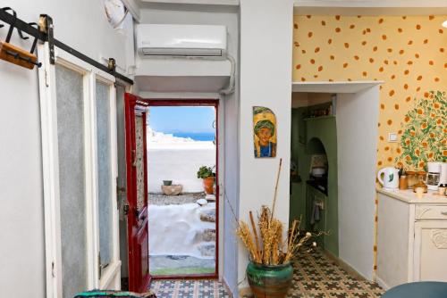 a room with a door leading to the beach at Danielle 626 House Ano Syros in Ano Syros