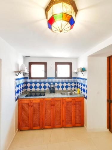 a kitchen with orange cabinets and a stained glass window at El Beaterio Apartments in Tarifa