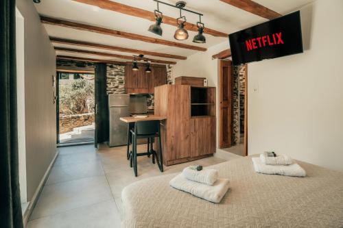 a room with two beds and a kitchen with a table at Ellafos Traditional Living-Elafonisi Couples Retreat in Elafonisi