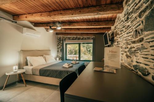 a bedroom with a bed and a stone wall at Ellafos Traditional Living-Elafonisi Couples Retreat in Elafonisi
