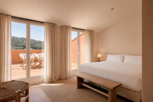 a bedroom with a bed and a large window at Finca Victoria, a Member of Design Hotels in Begur