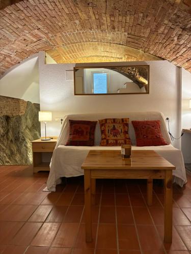 a bedroom with a bed with a table and a mirror at Loft con encanto in Cadaqués