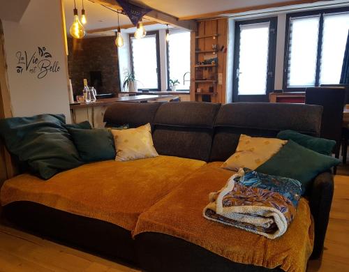 a living room with a couch with pillows on it at La Belle Tençoise in Tence