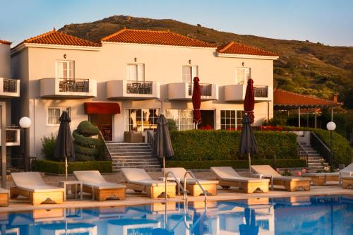 a hotel with a pool in front of a building at HOTEL BELLA VISTA in Mythimna