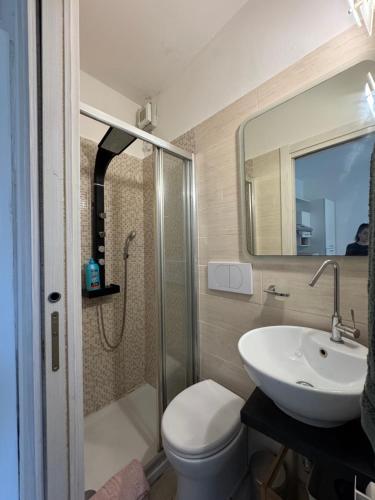 a bathroom with a sink and a toilet and a shower at Artdeco in Lecco