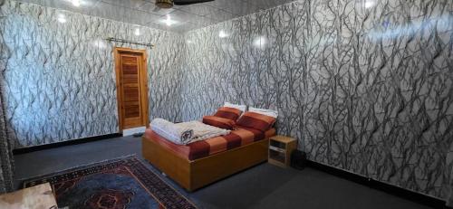 a room with a couch in a room with a wall at Shangrella Hotel Malam Jabba in Malam Jabba