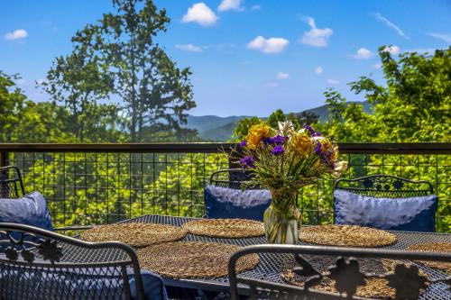 a table with a vase of flowers on a balcony at A Tree Top View home in Gatlinburg