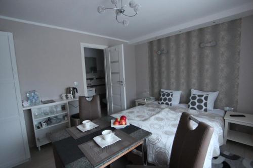 a bedroom with a bed and a table and a dining room at Modern in Zgorzelec