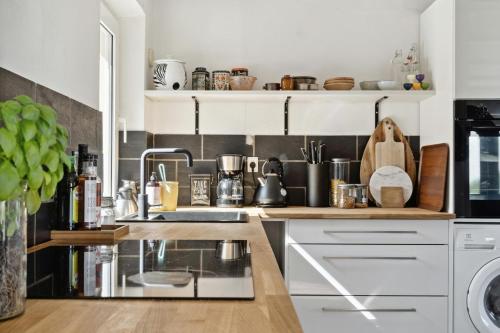 a kitchen with white cabinets and a counter at Stone House's Simplicity In Jerup's Vicinity in Jerup