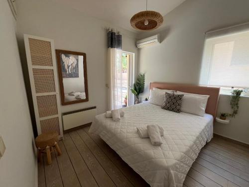 a bedroom with a bed with towels on it at Daphne Glyfada Corfu in Glyfada