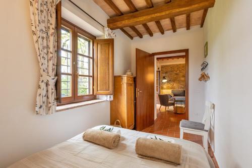 a bedroom with a large bed and a window at Countryhouse in Tuscany in Chianni