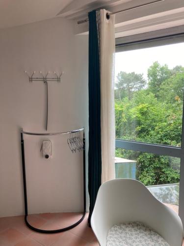 a white chair sitting in front of a window at COUETTE et CAFÉ L'AGENCE in Boutigny-sur-Essonnes