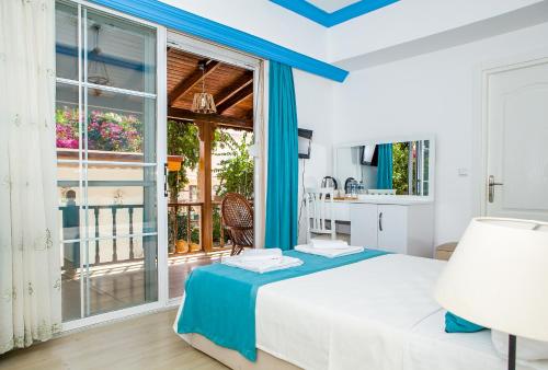 a bedroom with a bed and a large window at MERVE BUTİK OTEL in Didim