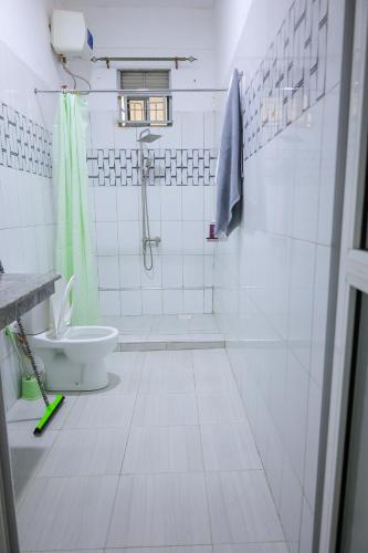 a bathroom with a shower and a toilet at The Comfort Den in Kampala