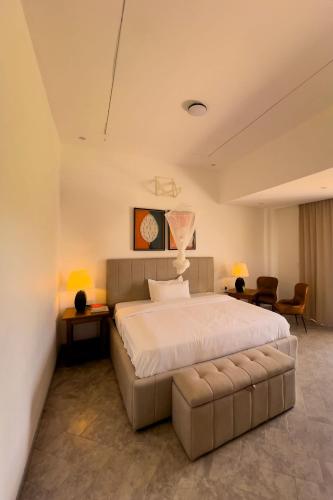 a large bedroom with a large bed and two chairs at Plenty Residence by Splendid Hotel, Retreat & Group Stay Near Kigali in Runda