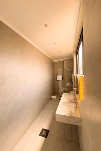 a bathroom with a sink and a toilet at Plenty Residence by Splendid Hotel, Retreat & Group Stay Near Kigali in Runda