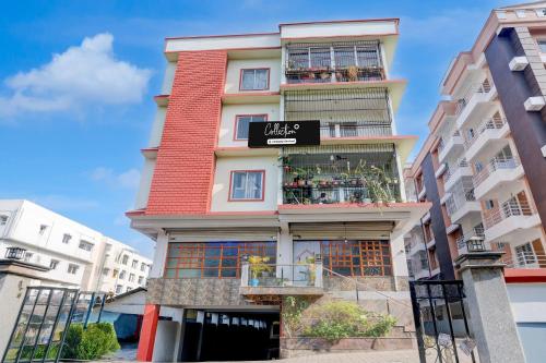 a tall building with a sign on it at Super Collection O Bashista Chariali Formerly Luit Heritage in Dispur