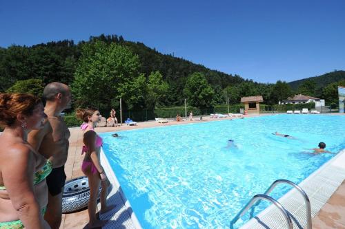 a group of people standing around a swimming pool at Chalet 4 étoiles - Piscine - ccbg00h in Celles-sur-Plaine